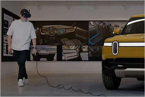 Engineer at Rivian walking around vehicle with VR headset on