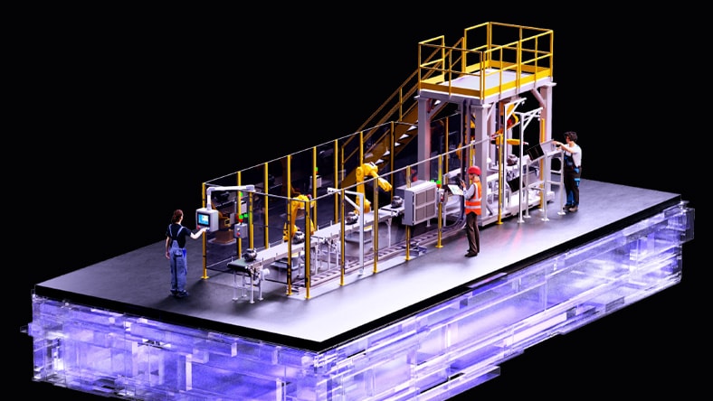 Production engineer working on tablet, standing in front of robotic arms