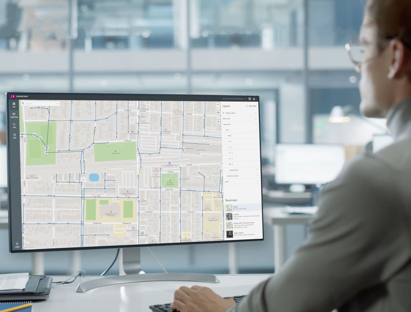A man looks a overhead view of a pipe network on Info360 Asset