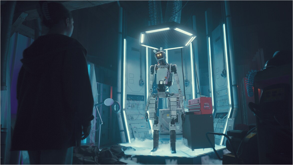 Robot standing on platform and looking at girl.