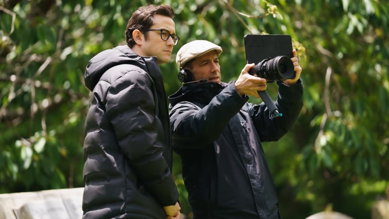 Two people discussing film footage during on-set production.