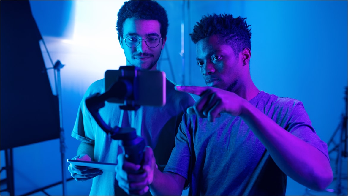 Camera operator discussing new content with director during on-set production.