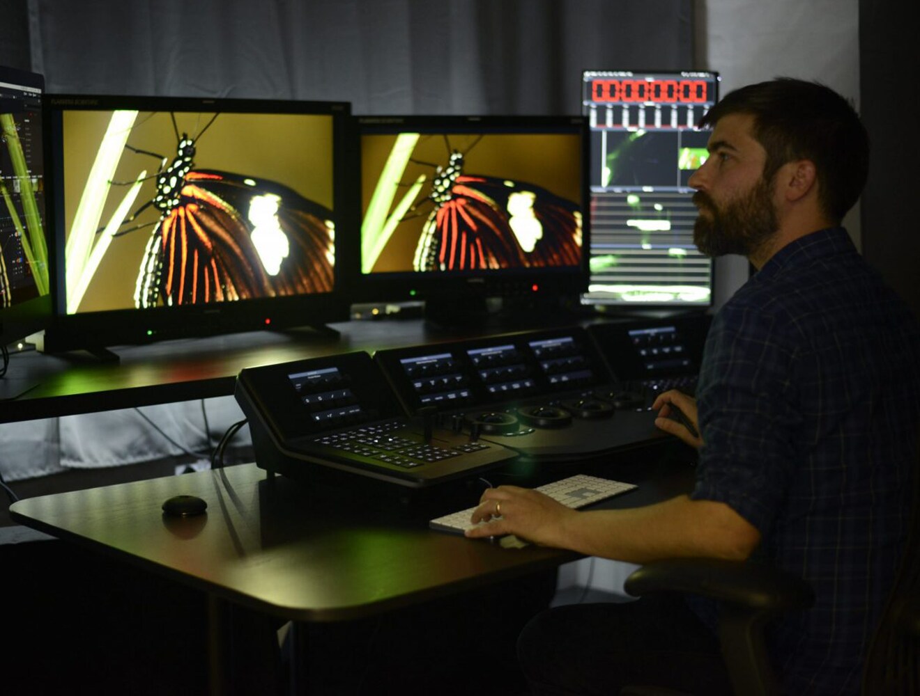 Man reviews video footage in studio.