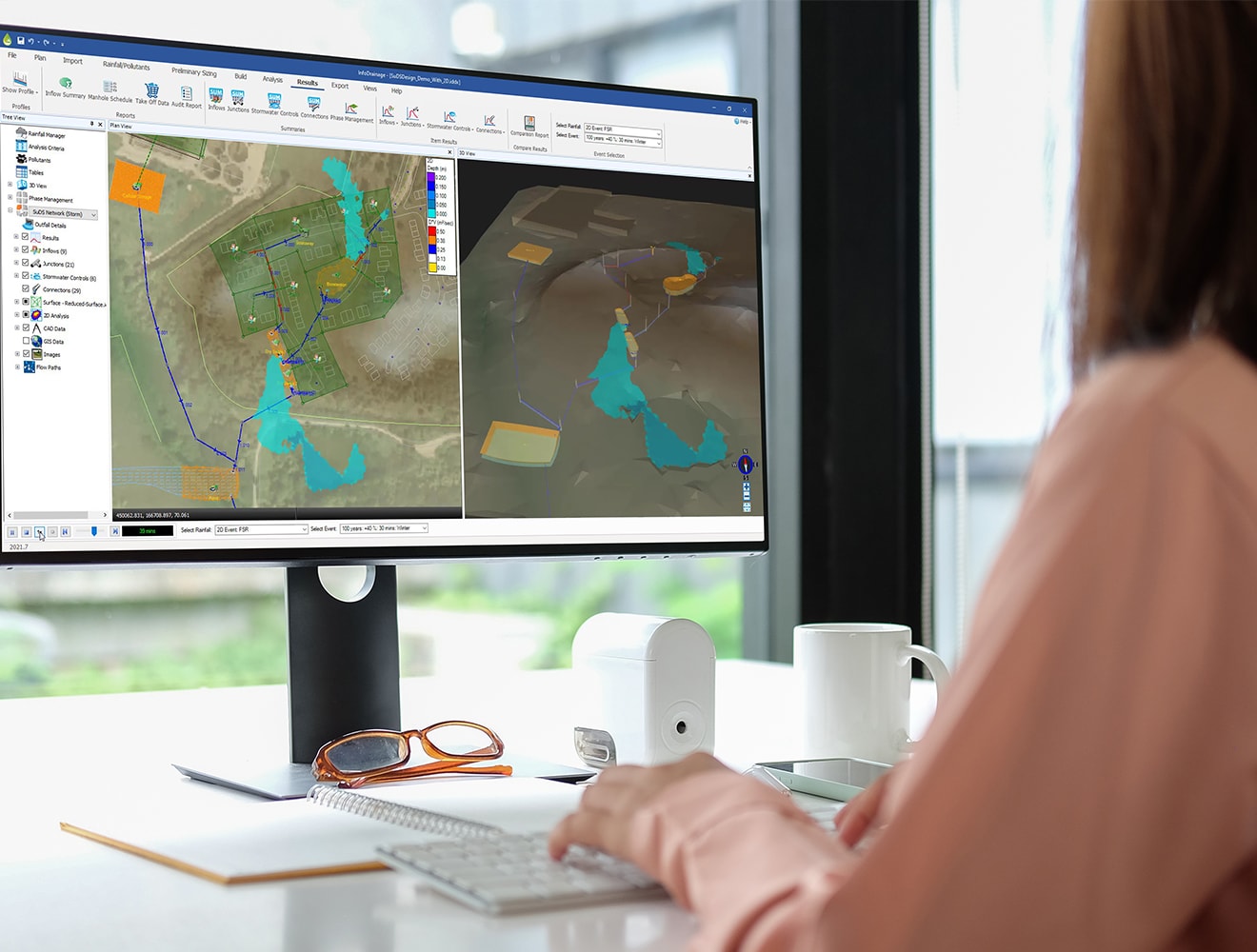 an engineer is working with  InfoDrainage software at the desk
