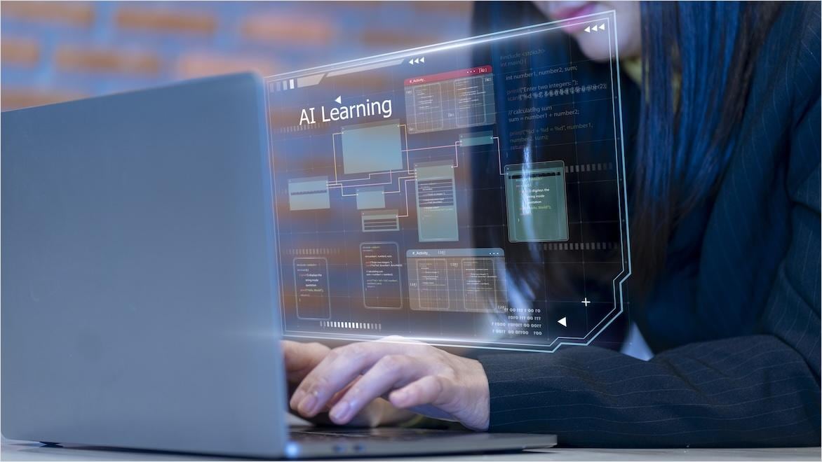 Close up of student on laptop, overlay relating to AI learning