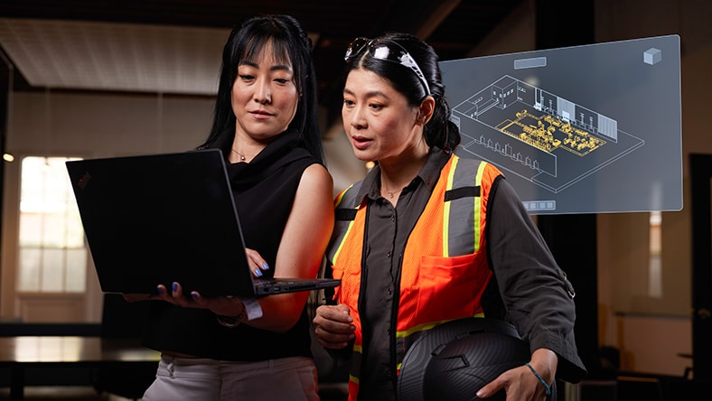 manufacturing engineer and production engineer looking at factory model