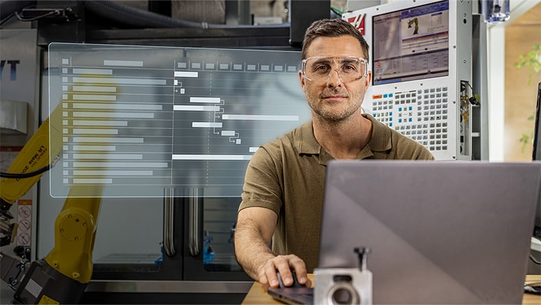Man working on computer with configurable project template for NPI workflow displaying