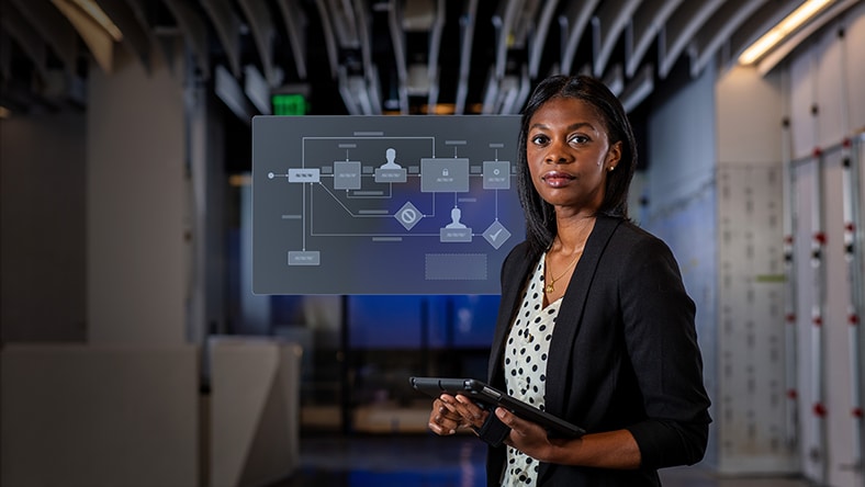 Woman holding tablet displaying engineering change order workflow