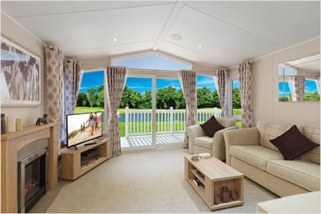 Living room with couch and view of sunny backyard