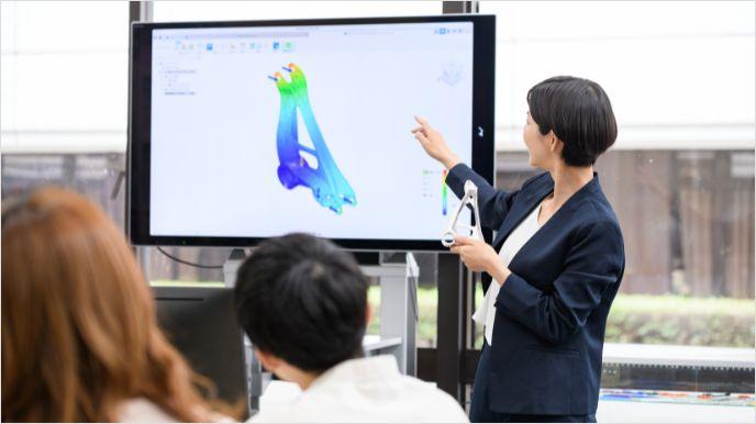 Person instructing and pointing to television screen