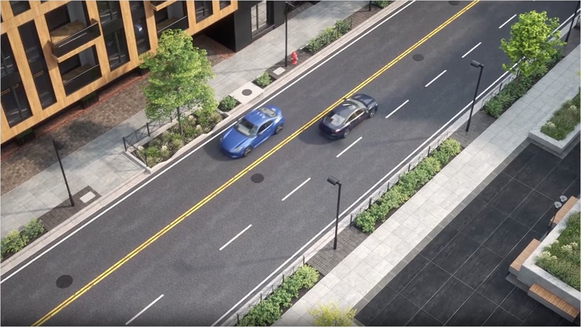 Top down view of a road with cars driving across