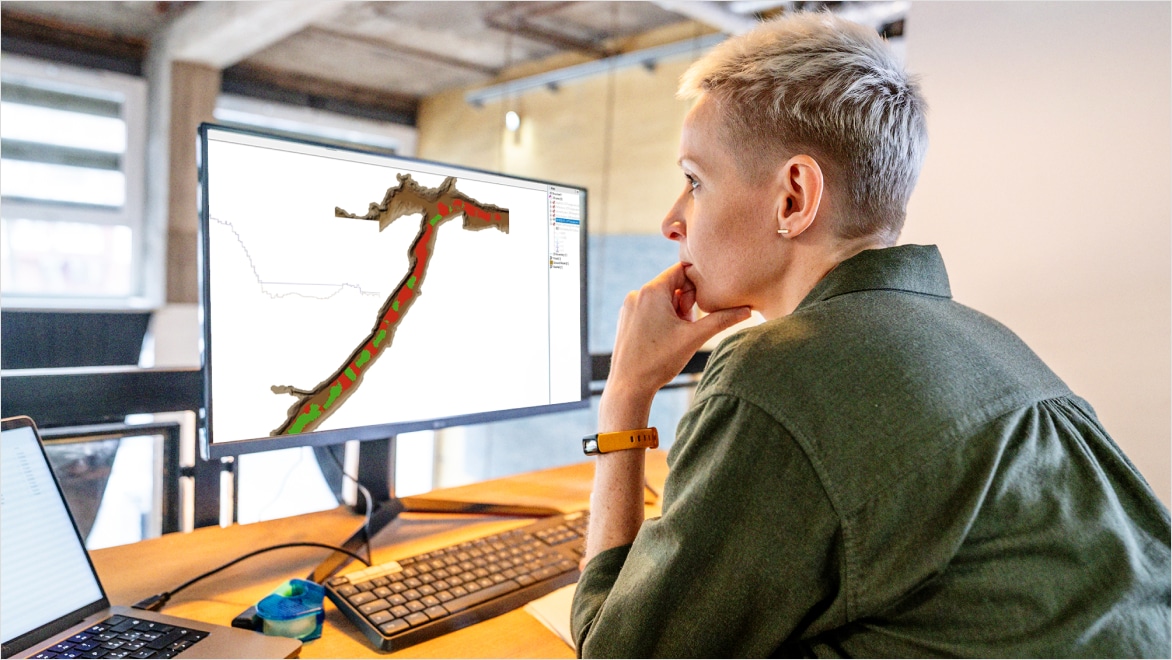 Engineer sat at a computer, modeling stormwater in InfoWorks ICM