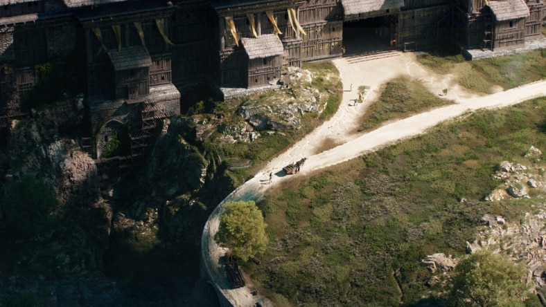 Aerial view of a wooden compound and unpaved road