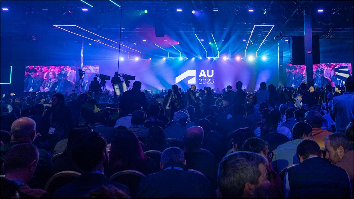 A crowd of people in a dark convention room attending an AU event in 2023