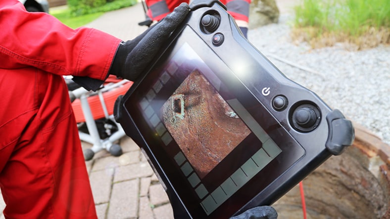 An engineer reviewing CCTV footage in the field