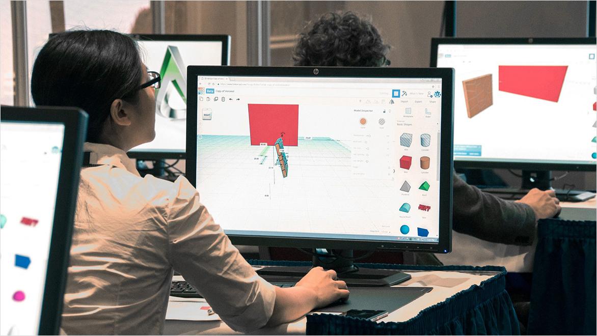 Students in a classroom work on the TinkerCAD web app.