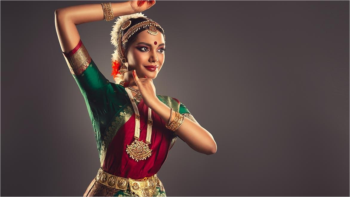 Woman dressed in a traditional Indian dance suit shows beauty of classic dance.