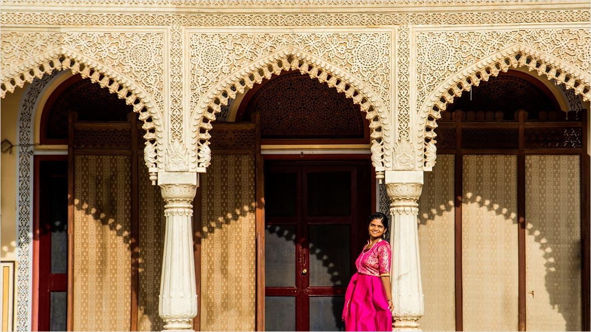 Indian young woman tourist at city palace Jaipur in Rajasthan state, India