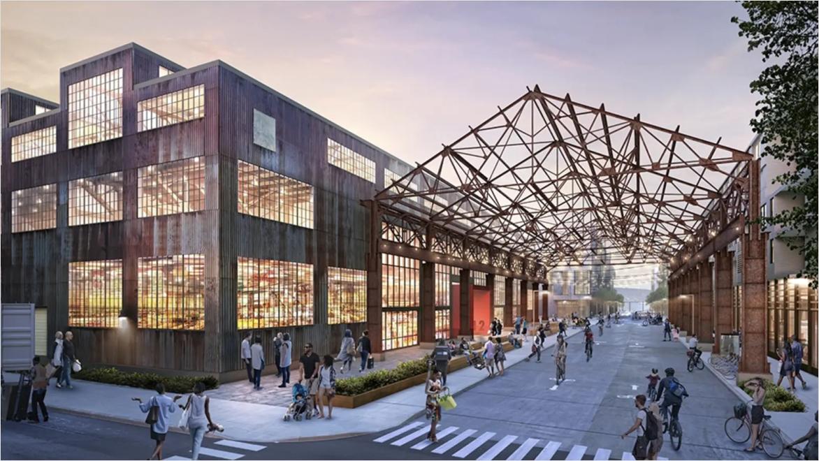 building at twilight next to street with pedestrians and bicyclists