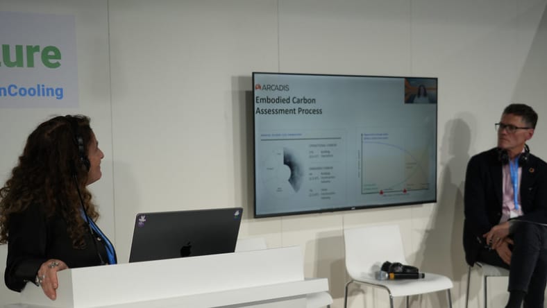 A man and a woman watching a screen