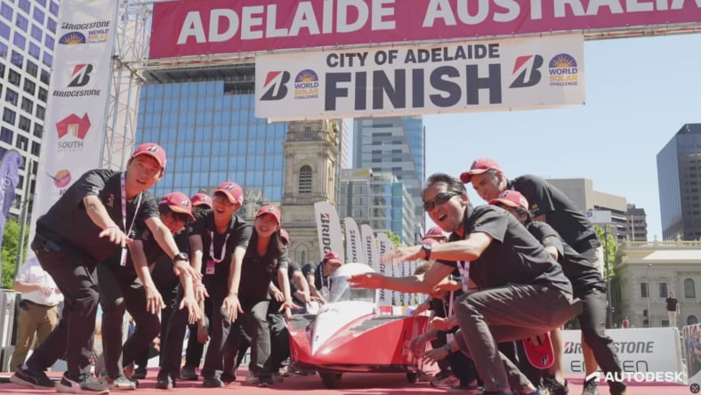 Professor Hiroto Yamane leading a celebration at the finish line with his Kogakuin University students