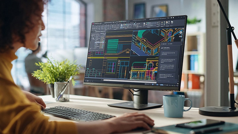 a person at a desktop montior using autocad plus