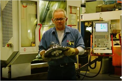 Engineer holding impeller designed with iLogic design automation technology in Autodesk Inventor