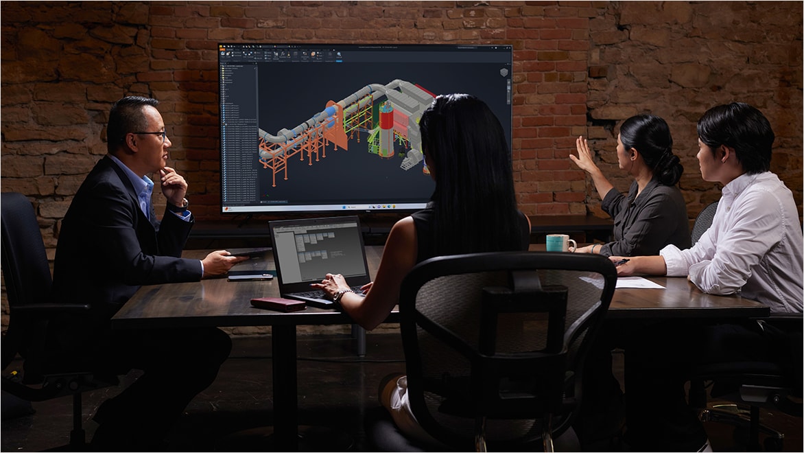 Meeting in design and engineering office to discuss industrial equipment development process