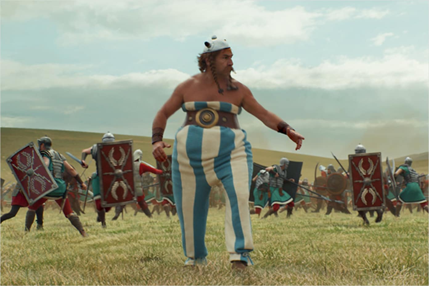 Obelix walking in a field among an army of Romans.