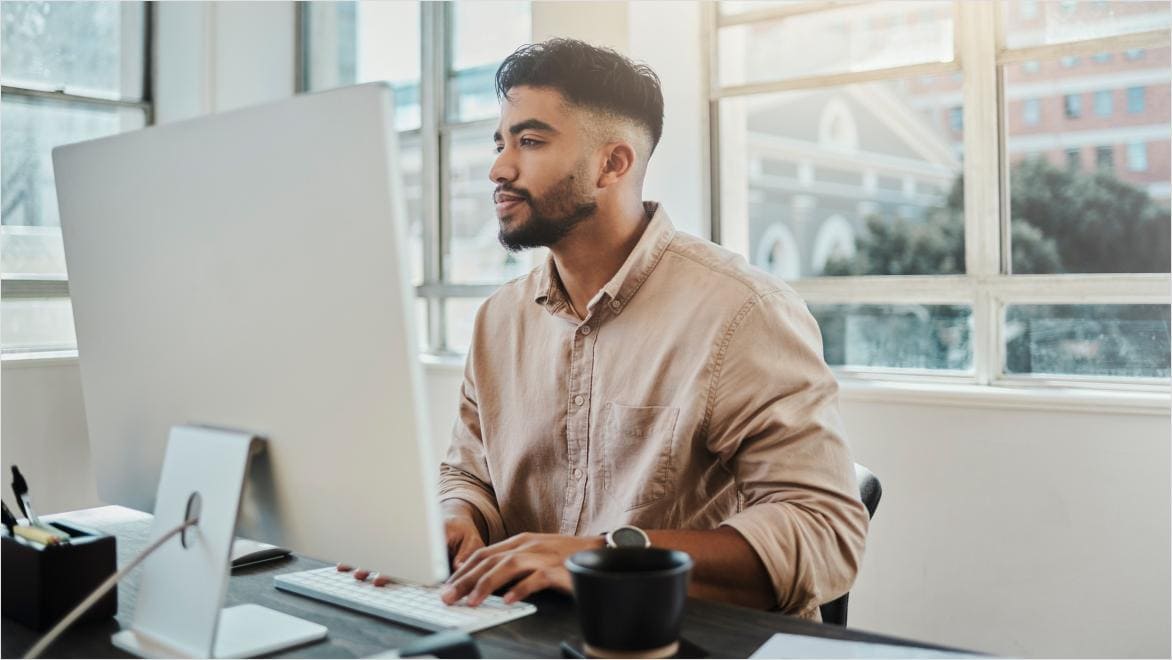 Man working on laptop using design AI worflows