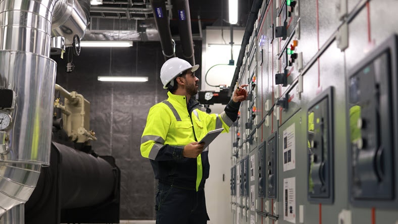 Engineers working in the main control room of a state-of-the-art chiller HVAC system