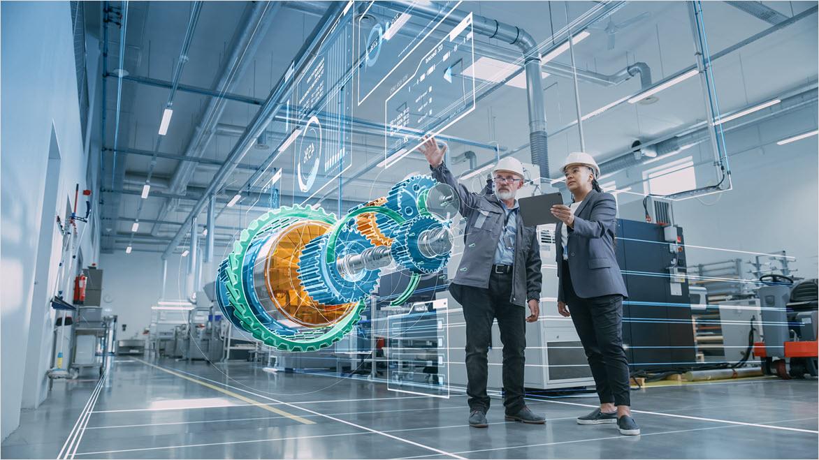 Due ingegneri industriali utilizzano un tablet per visualizzare un modello 3D di un motore a energia pulita e sostenibile.