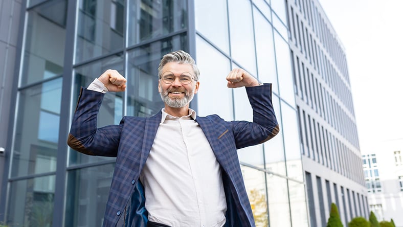 business man flexing muscles