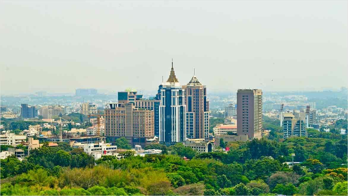 Bangalore city scape with trees in foreground. Image courtesy of Shylendrahoode