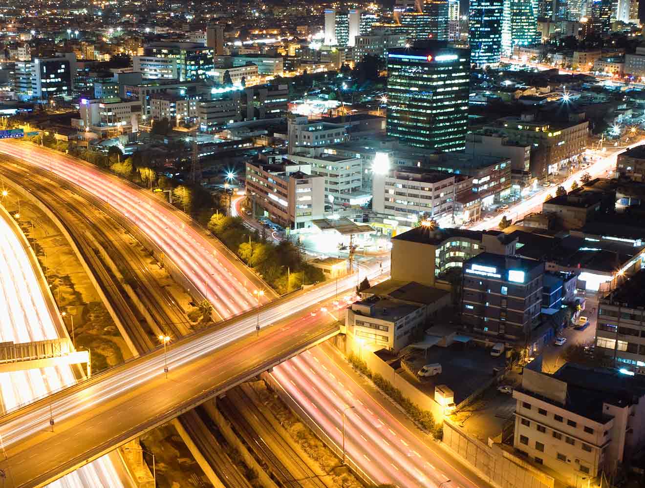 Aerial view of freeways at night.