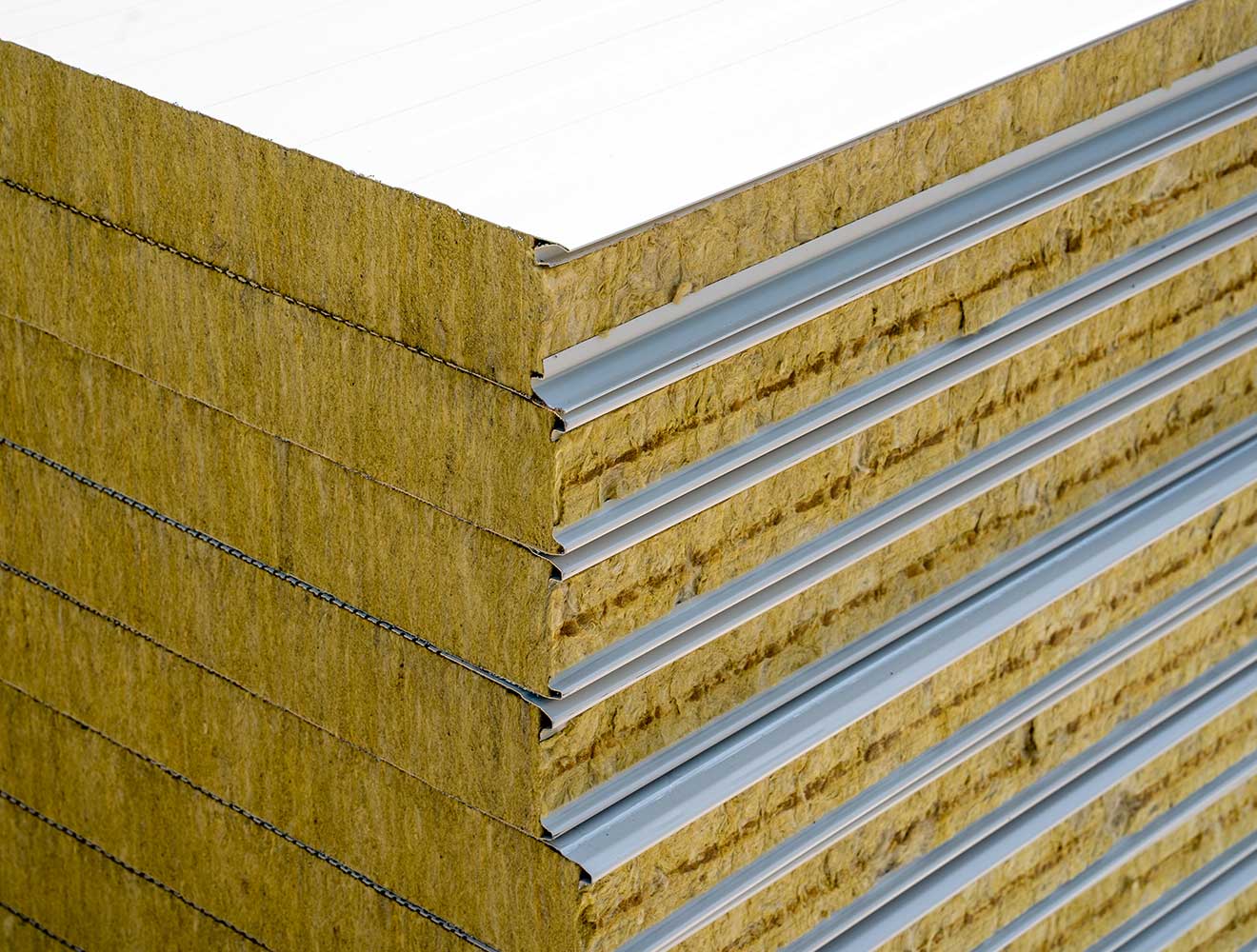 Modern office lobby with glass walls and open staircase.