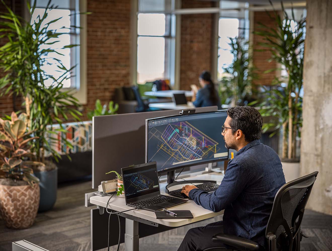 Man using AutoCAD in an office environment.