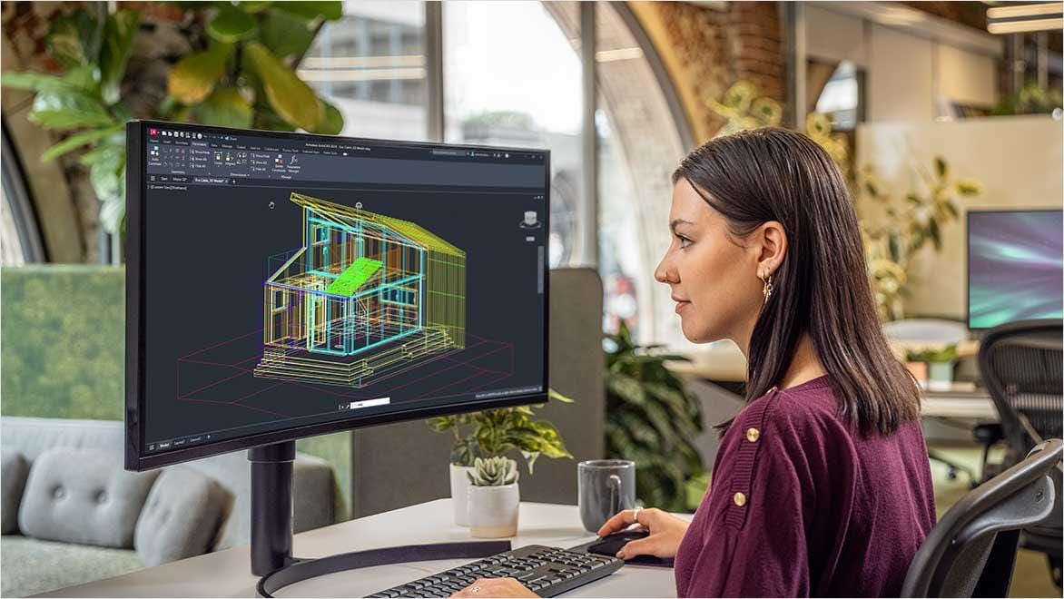 Woman using AutoCAD in an office environment.