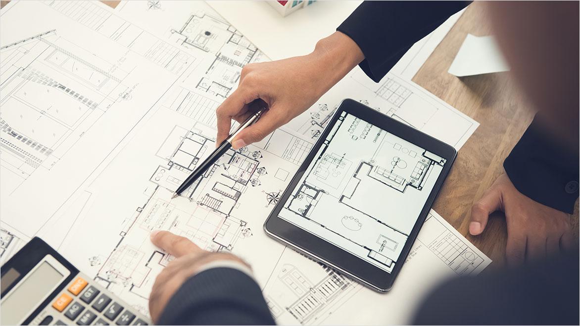 Architects or interior designers discussing floor plan blueprints