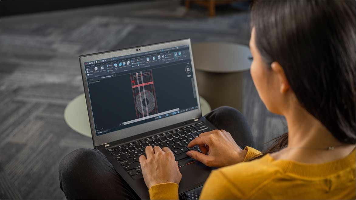 People using AutoCAD in a home office environment.