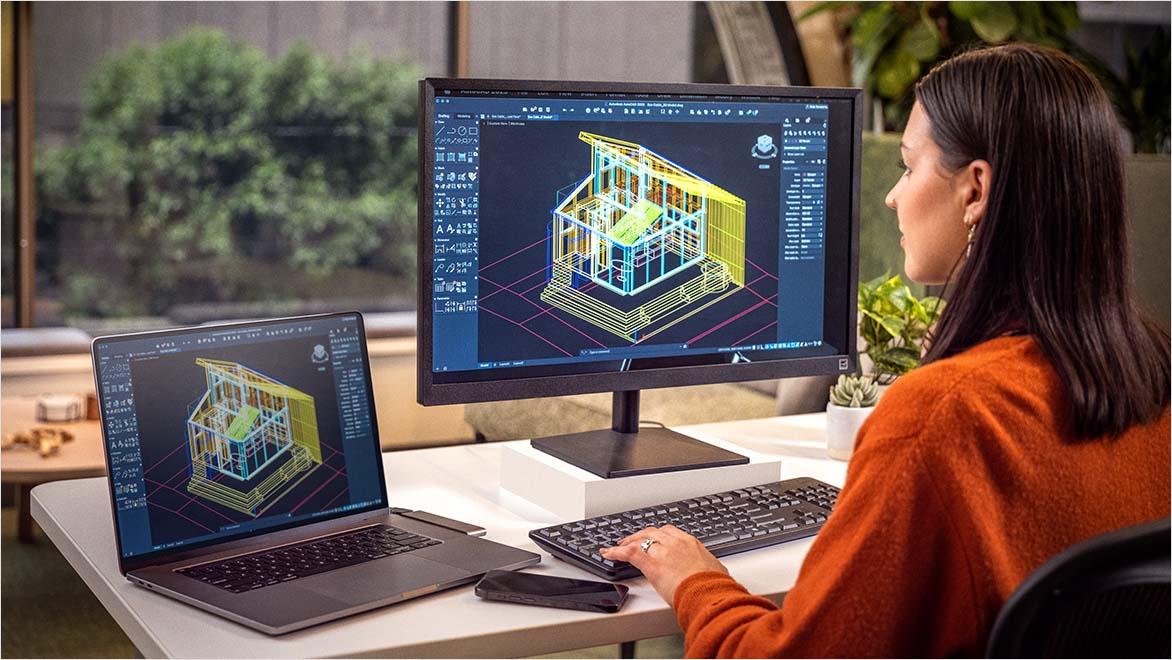 Woman using AutoCAD in an office environment.