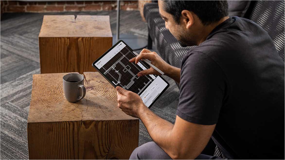 People using AutoCAD in a home office environment.