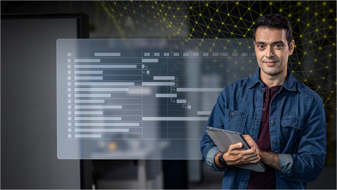 Man in denim shirt holding a tablet stands beside a transparent digital display showing a chart or project timeline. Background features a network visualization with connected nodes.