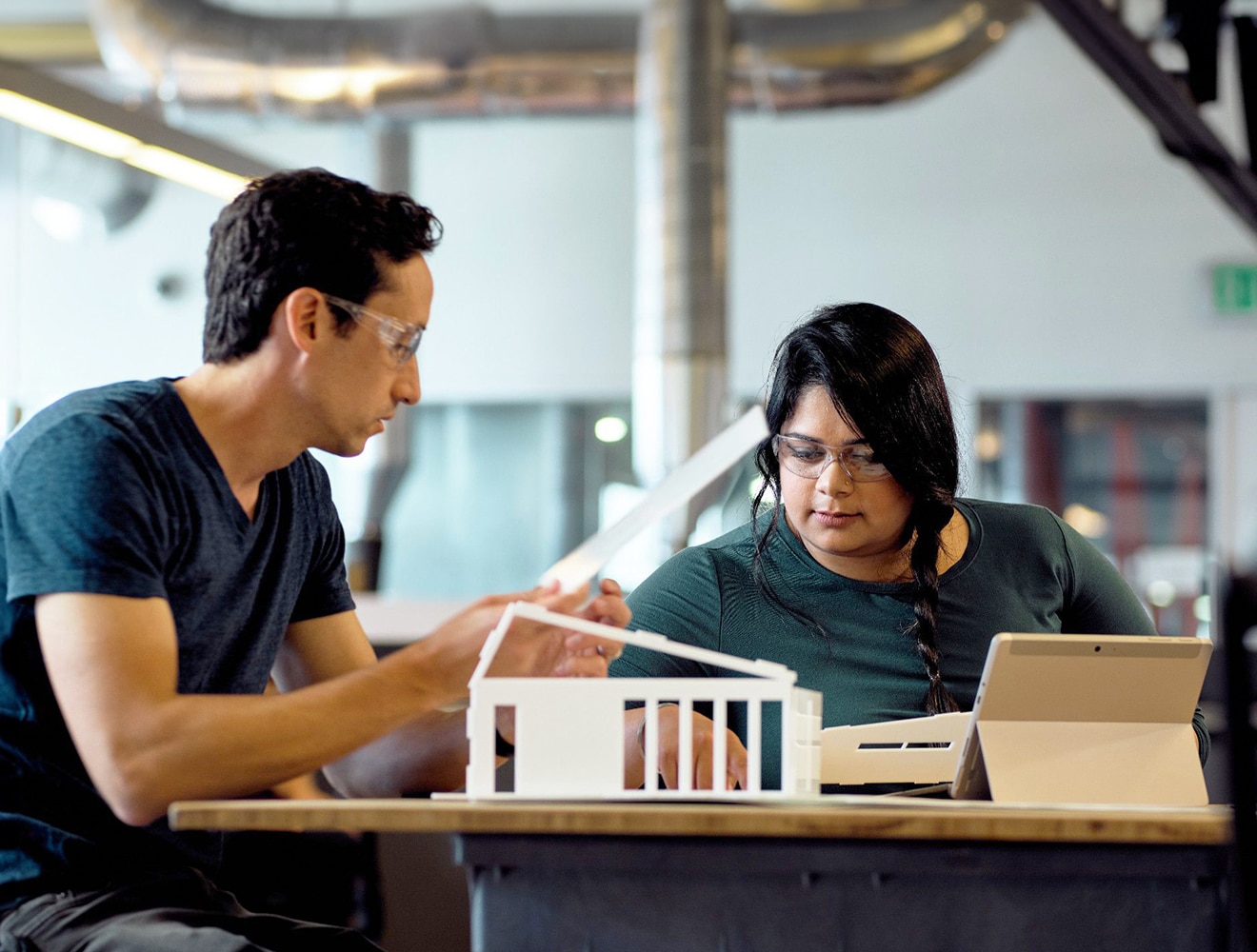 Two people with an architectural model