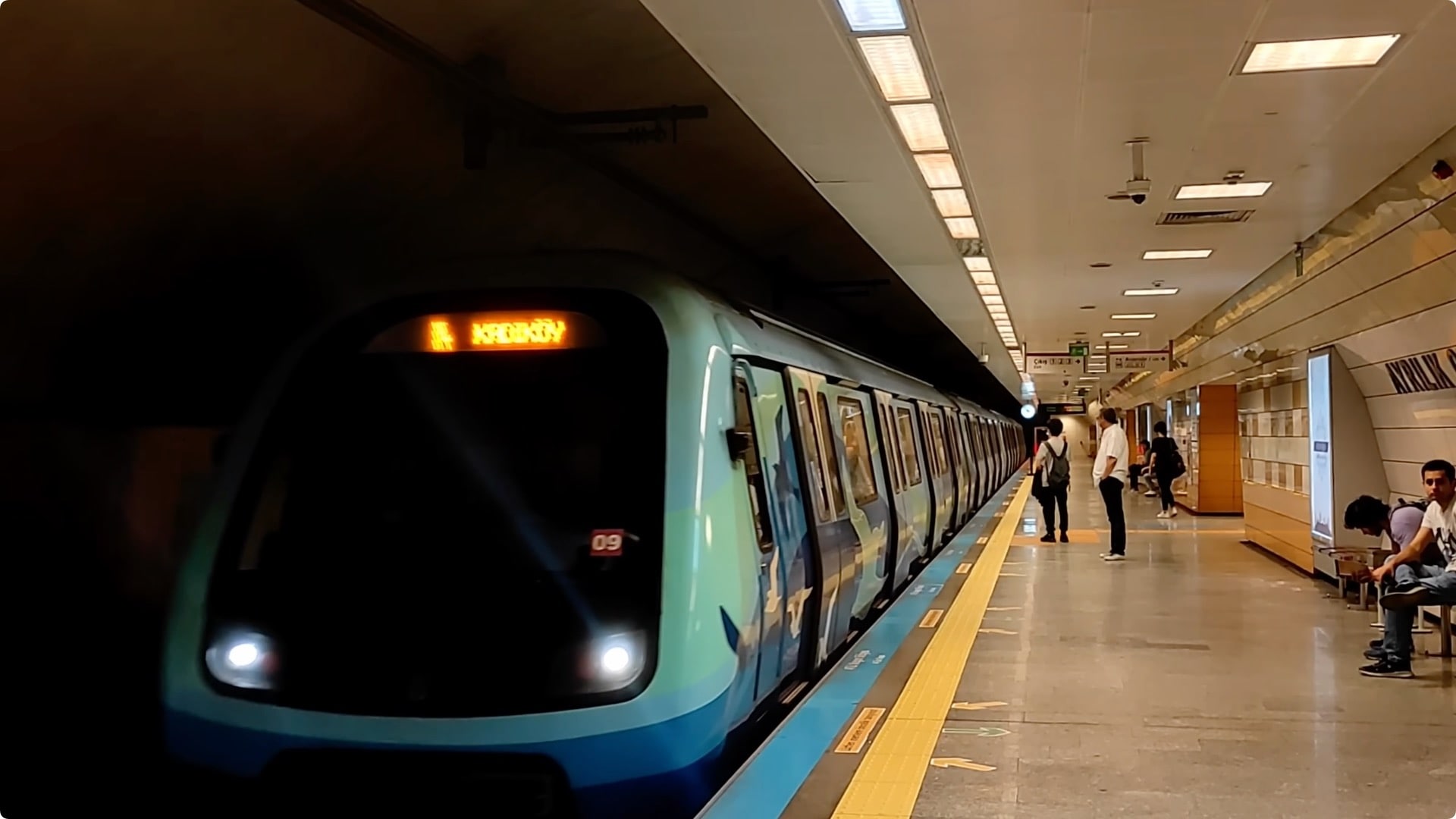 Modern metro train stopped at an underground station