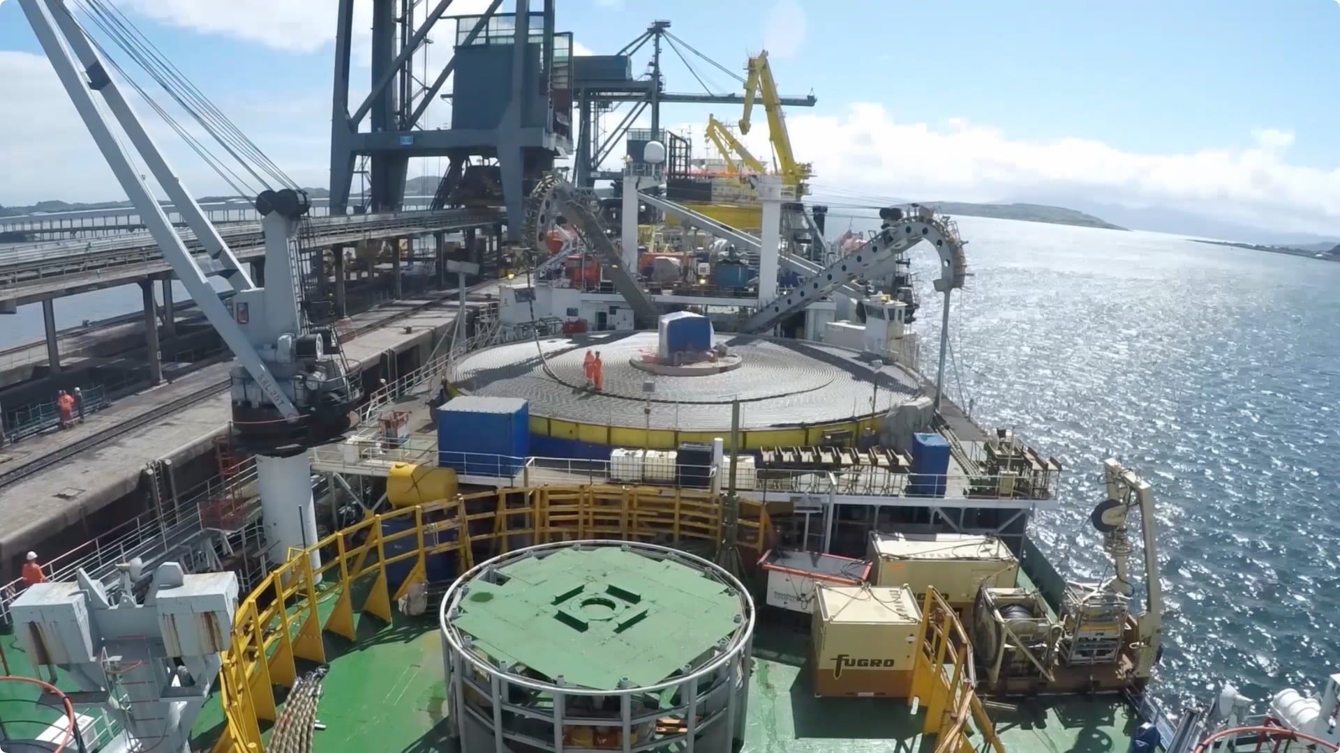 Modern offshore power plant with shoreline in the distance