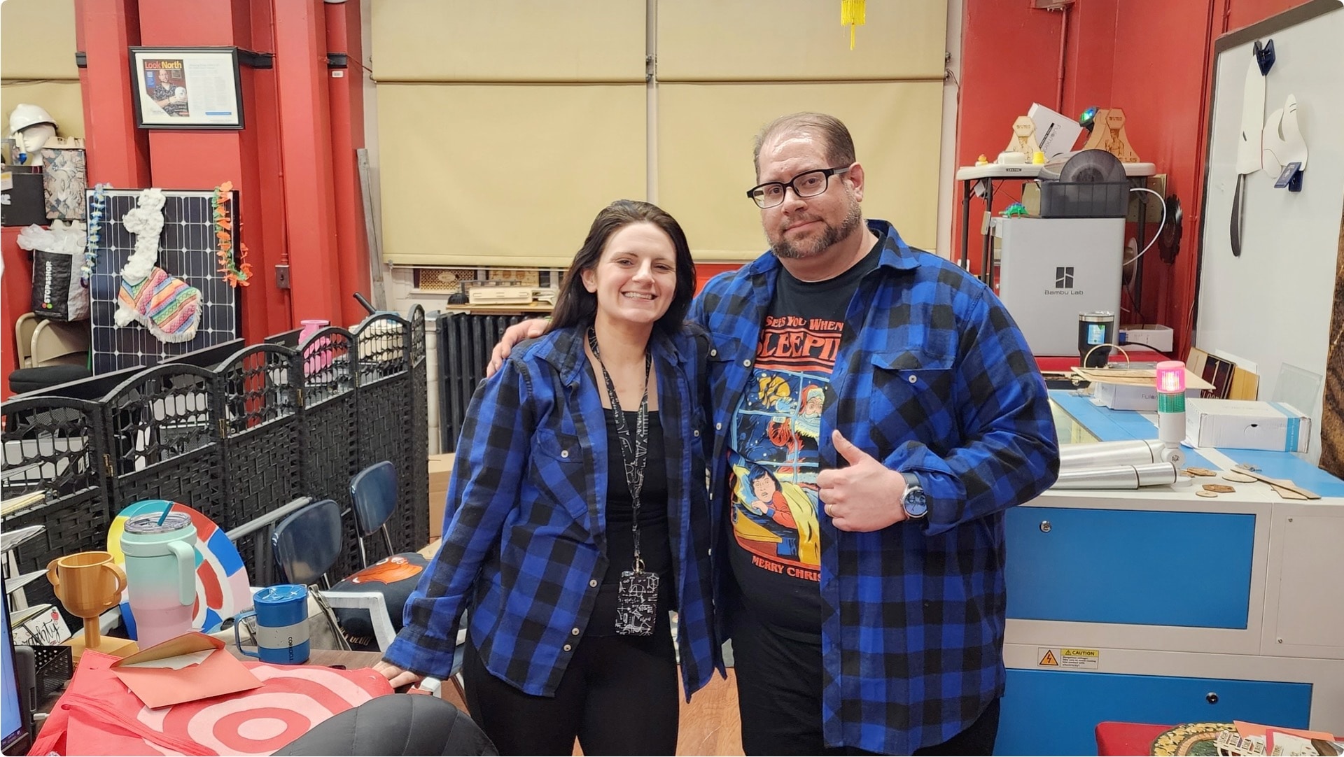 Closeup of a high school student holding up a hand and wrist encased in a 3D-printed support cast