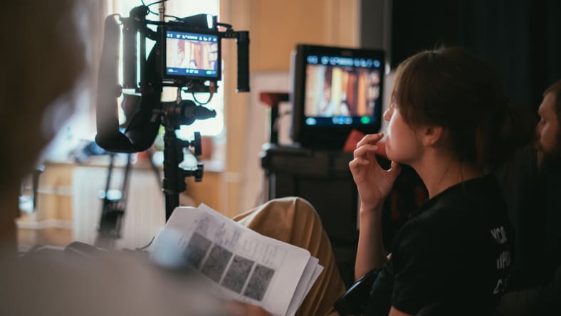 Director reviewing camera footage on set