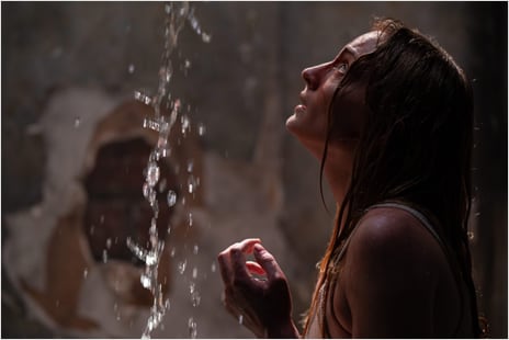 Woman looking up at ceiling with water leak