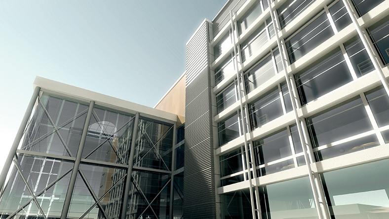 Modern glass and metal office building exterior under clear sky.